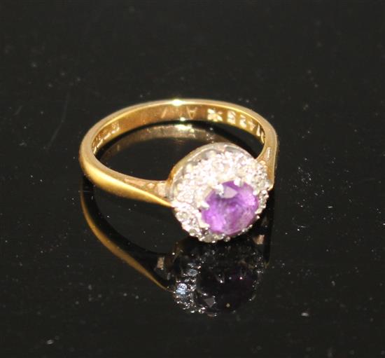 A modern 18ct gold, amethyst and diamond set circular cluster ring, size I, gross weight 3.2 grams.